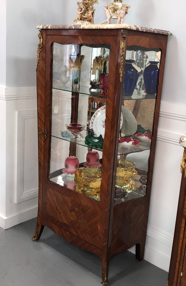 A Louis XV style Kingwood vitrine with marble top. It has beautifully floral inlay with ormolu mounts.