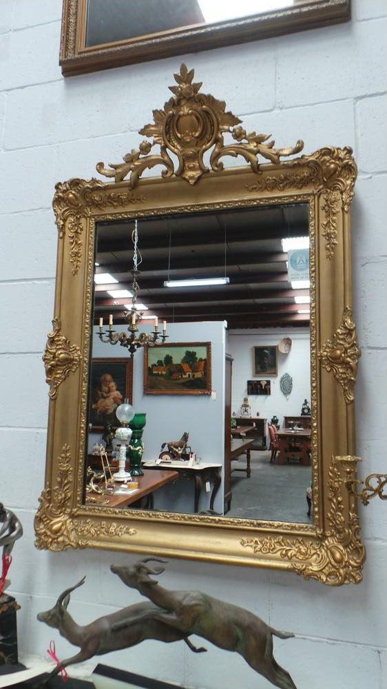 A French transitional Louis XV/Louis XVI style, gilded hanging wall mirror. In good restored condition.
