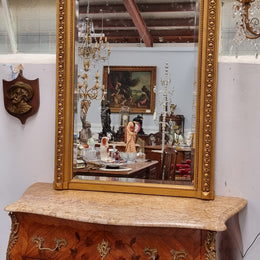 A stunning Napoleon III gilt mantle mirror with its original mirror. The top of the mirror is decorated with a beautiful laurel wreath and detailed decorative carving throughout. It is in good original condition with the bevelled mirror showing natural aging please view photo's.