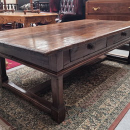 Impressive large size rustic French Oak coffee table with two drawers on a stretcher base. In good original detailed condition and sourced from France.