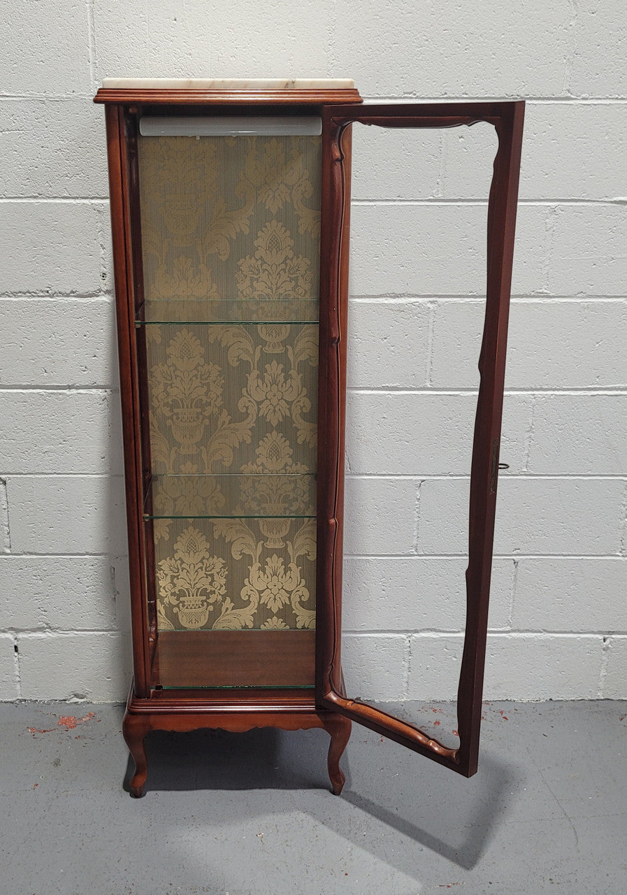French Louis XV style small scaled display cabinet with marble top. It is of pleasing proportions with a lovely olive french damask fabric back and two glass shelves. In good original detailed condition.