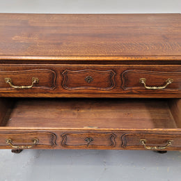 French Provincial Oak three drawer wooden top commode. It has elegant carvings and handles. It has been sourced from France and is in good original detailed condition.