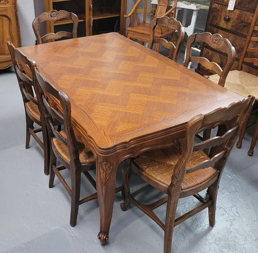 French Oak Louis XV style parquetry top extension table. It can sit six people when not extended and eight when fully extended. It has been sourced from France and is in original detailed condition.