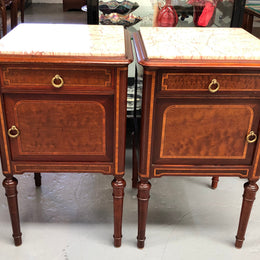 A lovely French inlaid pair of flame mahogany bedside cabinets with ormolu and in good condition.