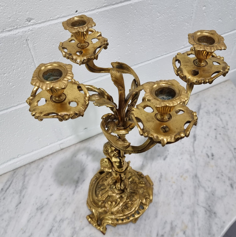 A pretty 19th Century French gilt bronze candelabra featuring a cherub. In good condition. Circa 1880.