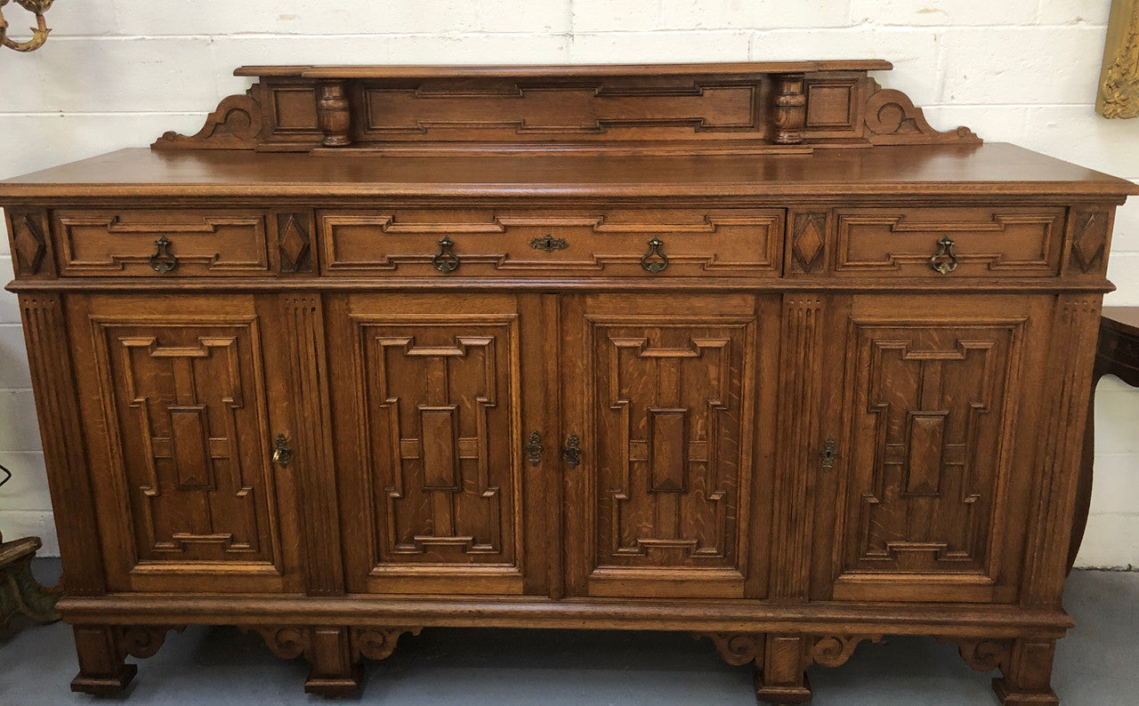 Beautiful carved French Oak four-door buffet with three drawers and lots of room for storage in good original detailed condition.