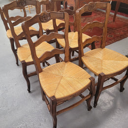 Set of six Louis XV style French Oak rush seat dining chairs. They are in good original detailed condition.