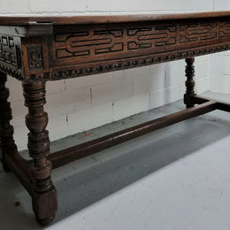 Rare and Charming 17th Century Spanish Walnut serving / side table. It has an incredible one piece walnut top with amazing character and colour. The base displays the original patina aswell as three drawers with carving and remnants of original locks. Superbly turned legs terminating on a stretcher base. Could be used as a large entrance console table, a side table or in a dining area as a serving table. In good original detailed condition especially considering its age.