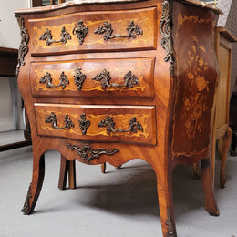 Antique French Louis XV style compact three drawer marble top commode with marquetry inlay and ormolu mounts. Sourced from France and in good original detailed condition.