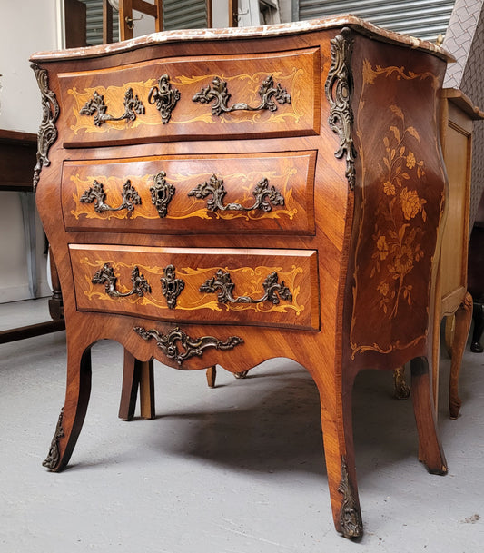 Antique French Louis XV style compact three drawer marble top commode with marquetry inlay and ormolu mounts. Sourced from France and in good original detailed condition.