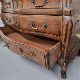 Impressive French Louis XV style Cherrywood four drawer commode, with a wooden top, two large drawers and two smaller drawers. Features attractive handles and a carved skirt and feet. In good original detailed condition.