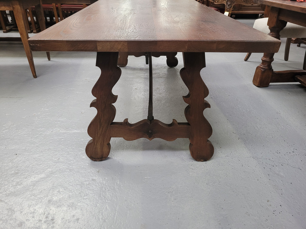 Spanish style French Oak farmhouse table with ironwork underneath. It is in good original detailed condition and has been sourced from France.