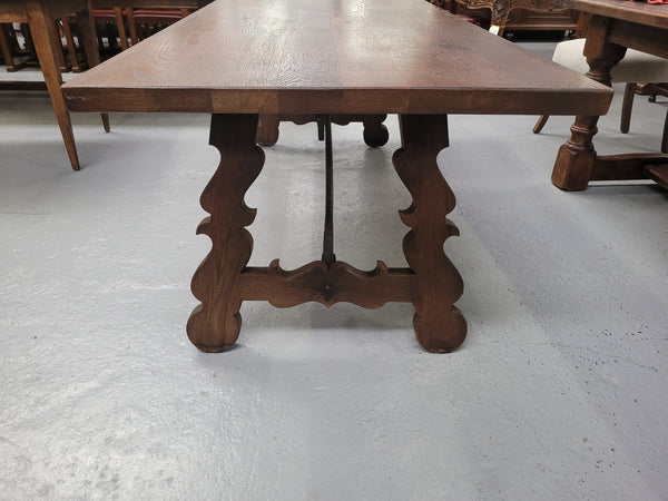 Spanish style French Oak farmhouse table with ironwork underneath. It is in good original detailed condition and has been sourced from France.