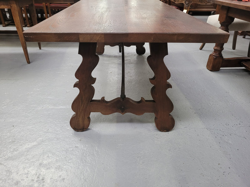 Spanish style French Oak farmhouse table with ironwork underneath. It is in good original detailed condition and has been sourced from France.