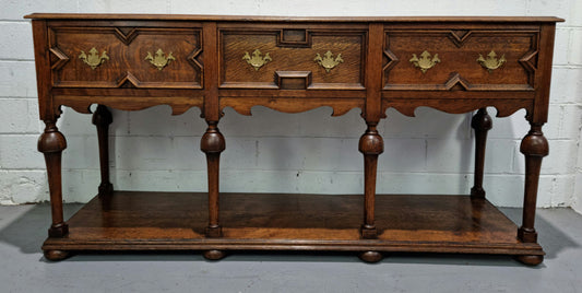 Lovely Antique Oak Tudor style kitchen dresser base with three deep drawers and lovely hardware. In good original detailed condition. There is also a dresser top with three shelves for display purposes. This piece can be purchased with or without top Price is the same either way.