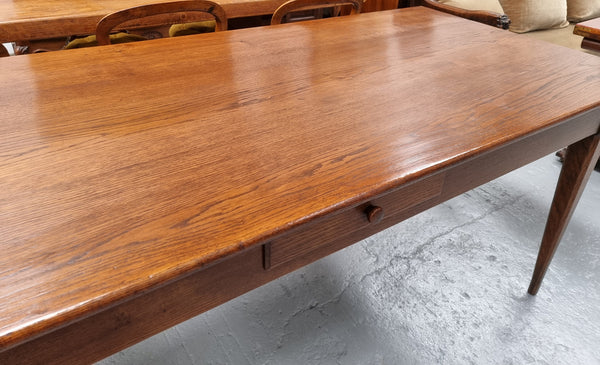 Antique French Oak Farmhouse table in fully restored condition. Features a single drawer and tapered legs.