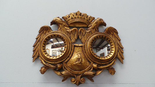 A unique and beautiful hand carved French gilt wood double mirror. It is 47 cm tall and 58 cm wide. From circa 1930 and in excellent restored condition.
