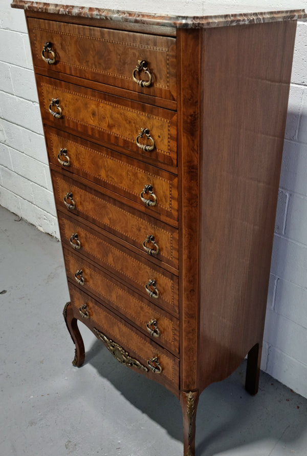 Louis XV style parquetry inlaid marble top semainier. It has seven drawers and a stunning coloured marble top. In good original condition.