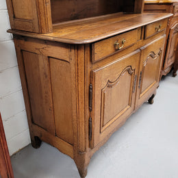 Charming 18th Century French Oak Vaisselier / kitchen dresser with two cupboard doors and three open shelves at the top. Sourced from France and in good original detailed condition.