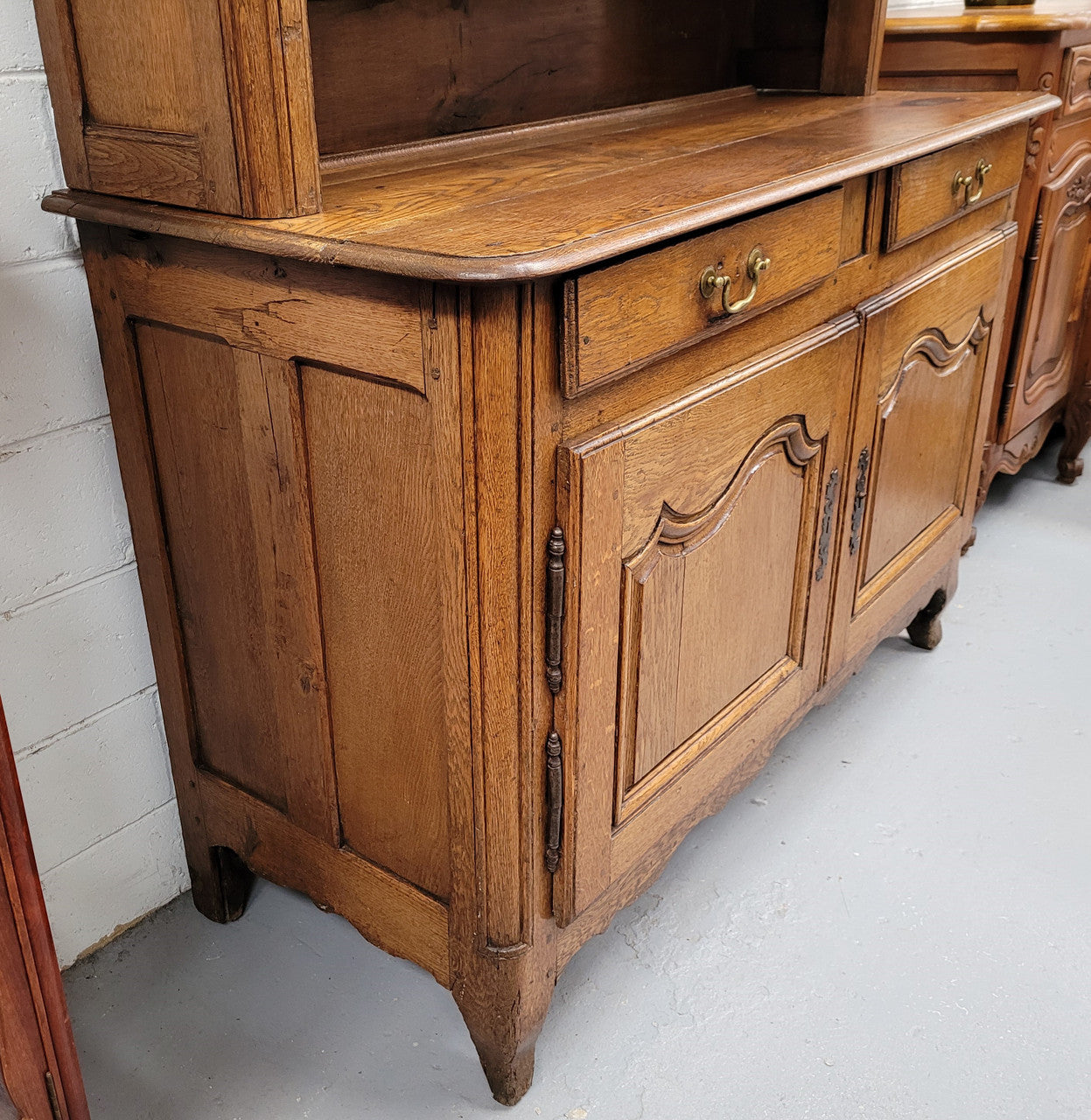 Charming 18th Century French Oak Vaisselier / kitchen dresser with two cupboard doors and three open shelves at the top. Sourced from France and in good original detailed condition.