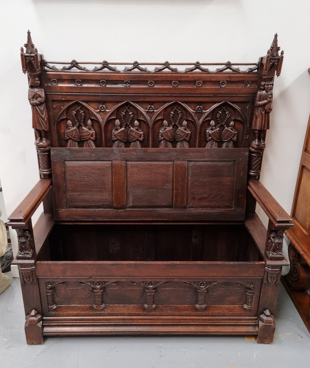 Early 19th Century French Oak Gothic style hall seat with a lift up seat. It has amazing detailed carvings and is in good original detailed condition.