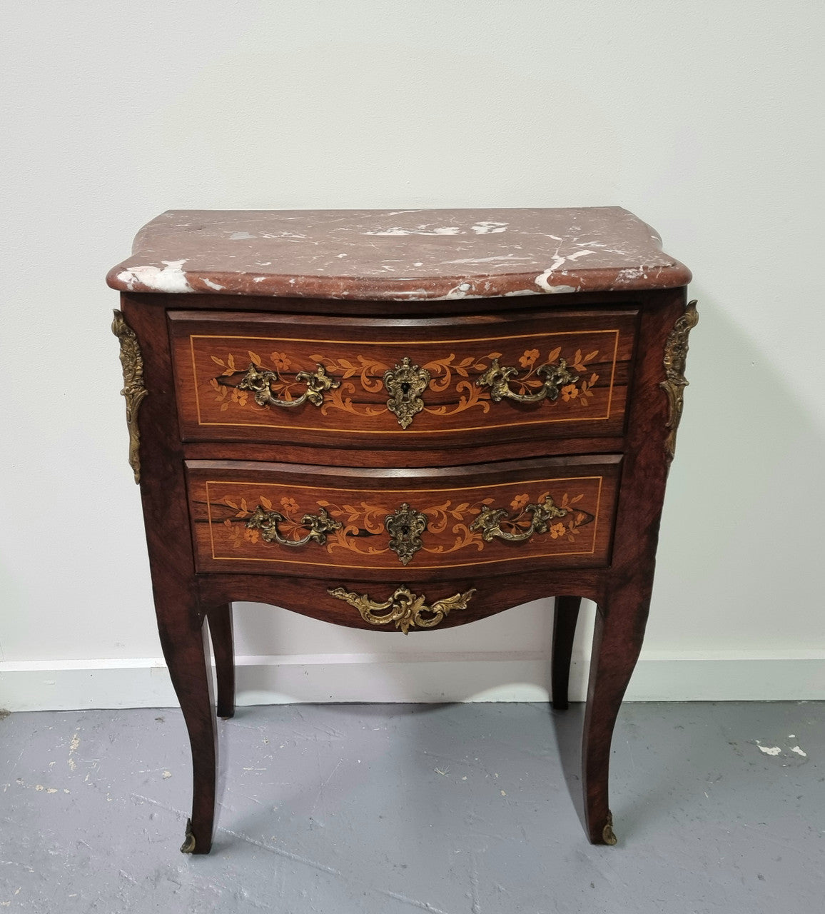 A stunning French petite two drawer inlaid Rosewood commode. In good original detailed condition.
