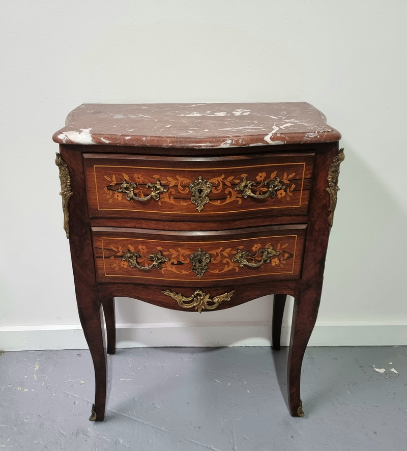 A stunning French petite two drawer inlaid Rosewood commode. In good original detailed condition.