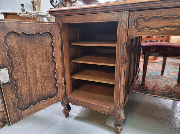 Fabulous Louis XV style French Oak beautifully carved full partners desk with an amazing tooled leather top. Both sides have a functioning drawer in the middle and two cupboards either side. On both sides one cupboard door opens up to four smaller internal drawers. Plenty of storage space and a large top surface to work on. It is in good original detailed condition.