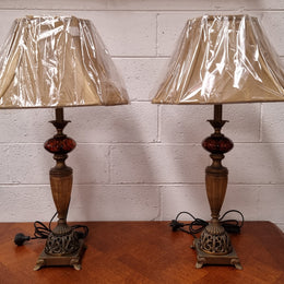 Beautiful pair of metal and glass lamp bases with new gold shades. They are in good original working condition and have been sourced locally.