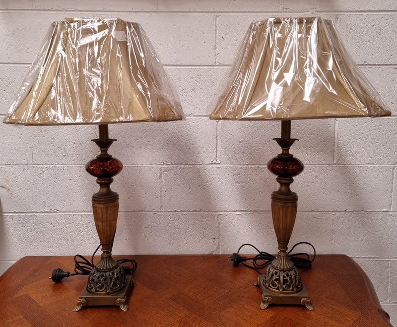 Beautiful pair of metal and glass lamp bases with new gold shades. They are in good original working condition and have been sourced locally.