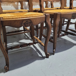A set of 6 French Louis XV style oak dining chairs with rush seats in good original condition. All chairs have been detailed and re-glued where needed.