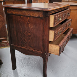 Rustic Louis XV style Oak petite three drawer chest featuring attractive carvings. It has been sourced locally and it is in good original detailed condition.