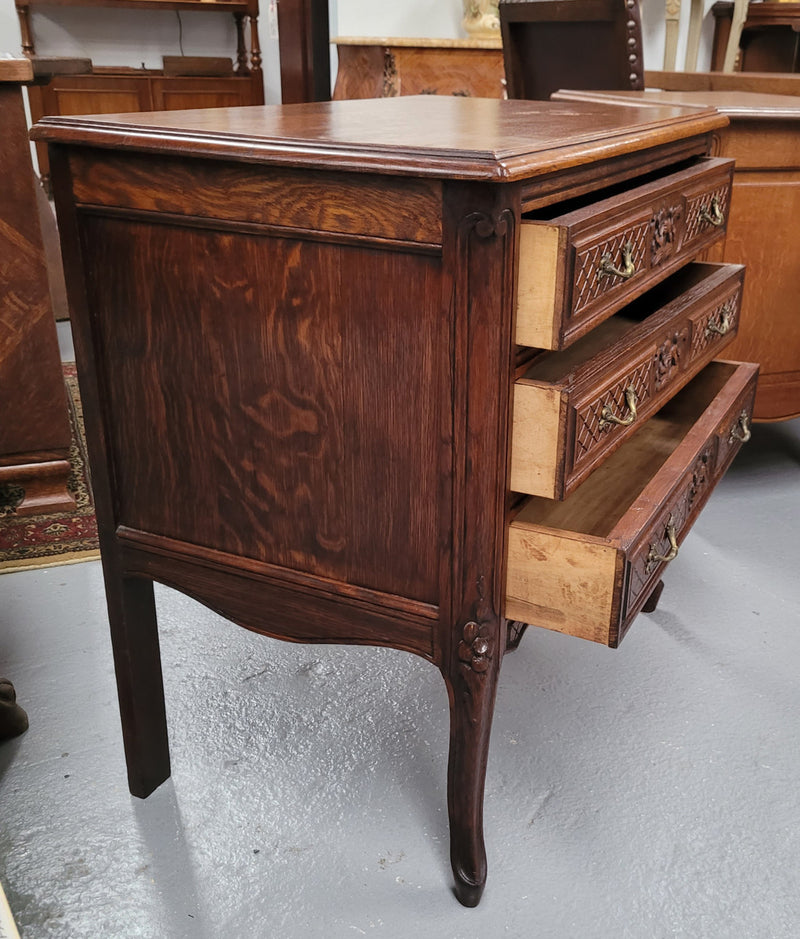 Rustic Louis XV style Oak petite three drawer chest featuring attractive carvings. It has been sourced locally and it is in good original detailed condition.