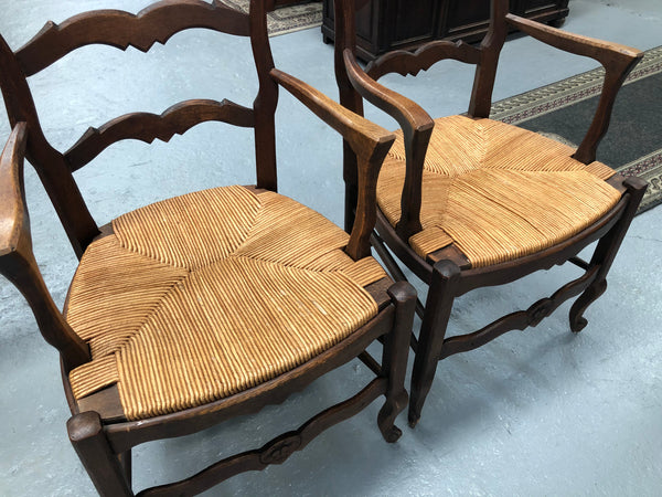 A hard to find French pair of rush seat carver chairs. They are in good original detailed condition.