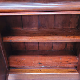 Mid 19th Century Australian Cedar and Flame Cedar tall bookcase. The top has two glass doors that open up to three adjustable shelves followed by a drawer in the middle and finishes with two beautiful wooden doors that open up to a fixed shelf. In good original detailed condition and has been sourced locally.