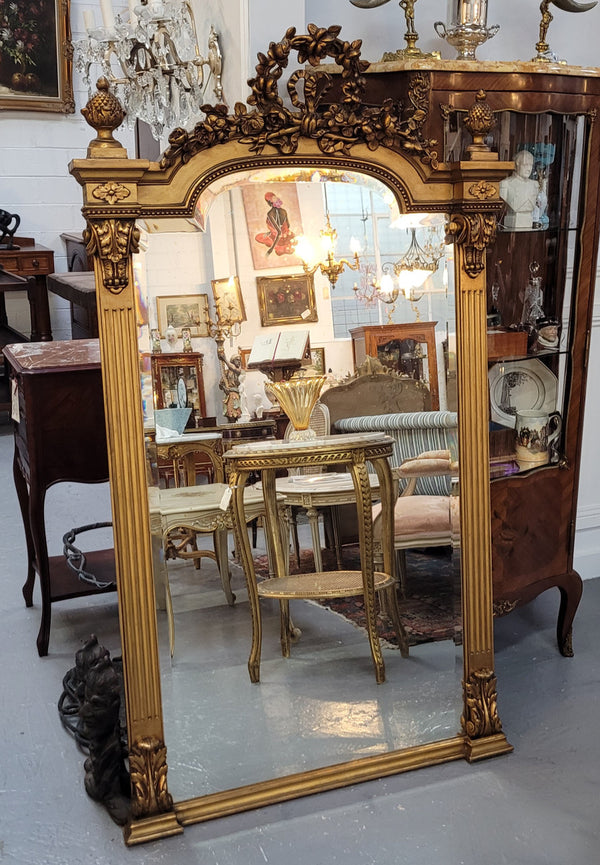 French Louis XVI style Napoleon III (1870’s) gilt mantle mirror. Beautifully carved and decorated with original bevelled mirror showing signs of age. It is in good original detailed condition and has been sourced from France.