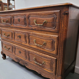 French Provincial Oak three drawer wooden top commode. It has elegant carvings and handles. It has been sourced from France and is in good original detailed condition.