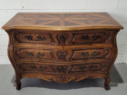 Impressive French Louis 15th style three drawer Commode featuring inlaid parquetry top and carving on drawers.