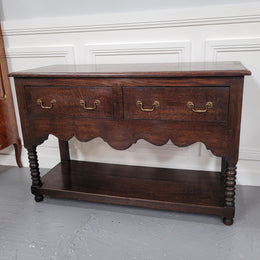 Rare size 19th Century English oak dresser base. It has two good size drawers and amazing patina. It has been sourced from France and in good original detailed condition.