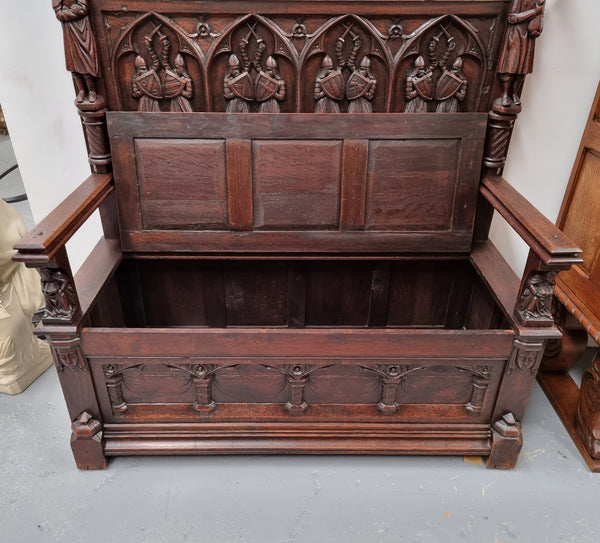 Early 19th Century French Oak Gothic style hall seat with a lift up seat. It has amazing detailed carvings and is in good original detailed condition.