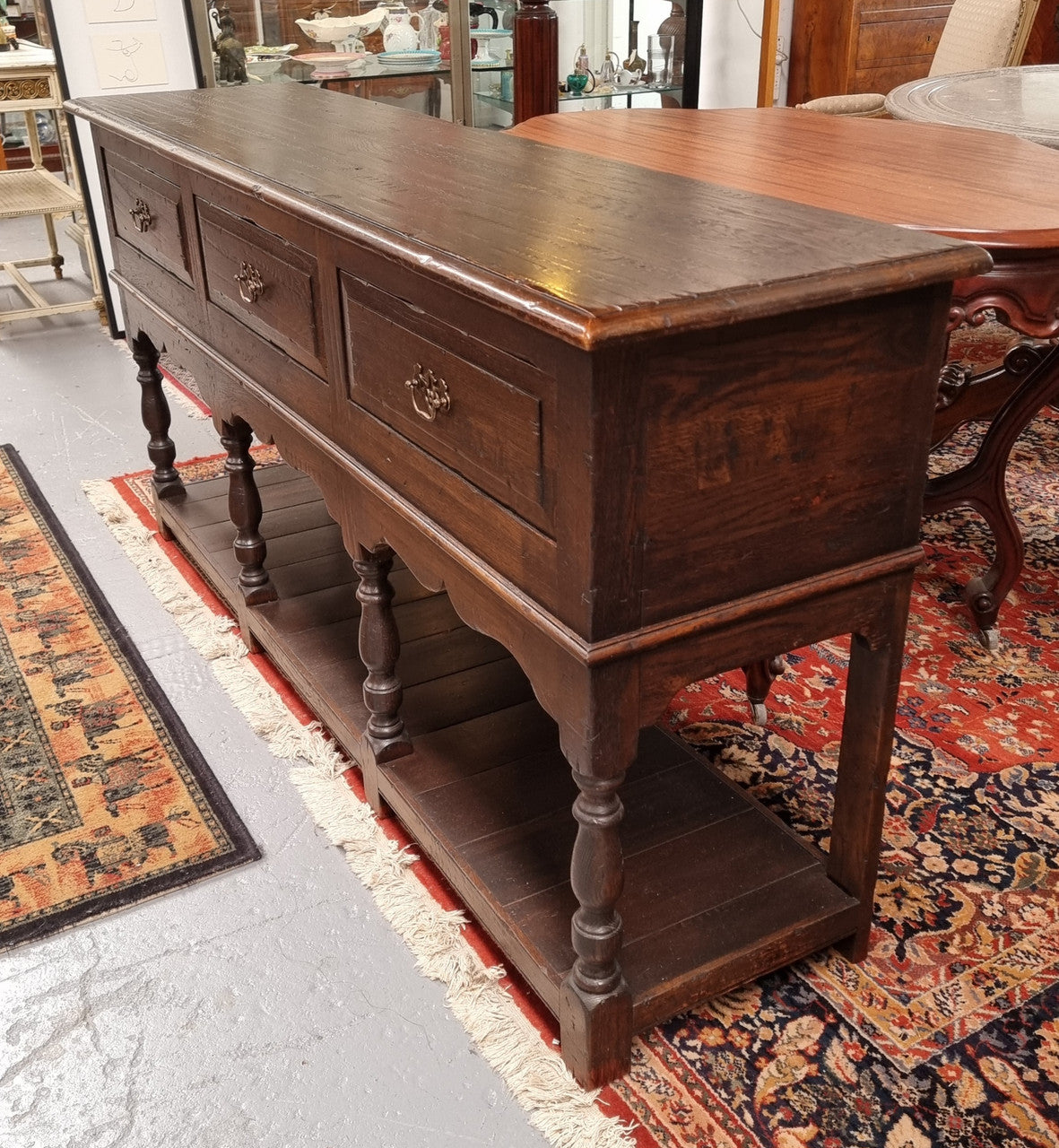 A very hard to find Vintage English kitchen dresser base of narrow proportions, sourced from France. In good original detailed condition.