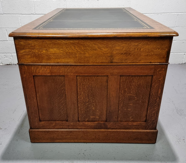 Amazing American Oak full partners leather top desk. Plenty of storage space with nine drawers on one side and two cupboards of the oppsite side. It is in good restored condition and has a new leather and gold tooled inset top.