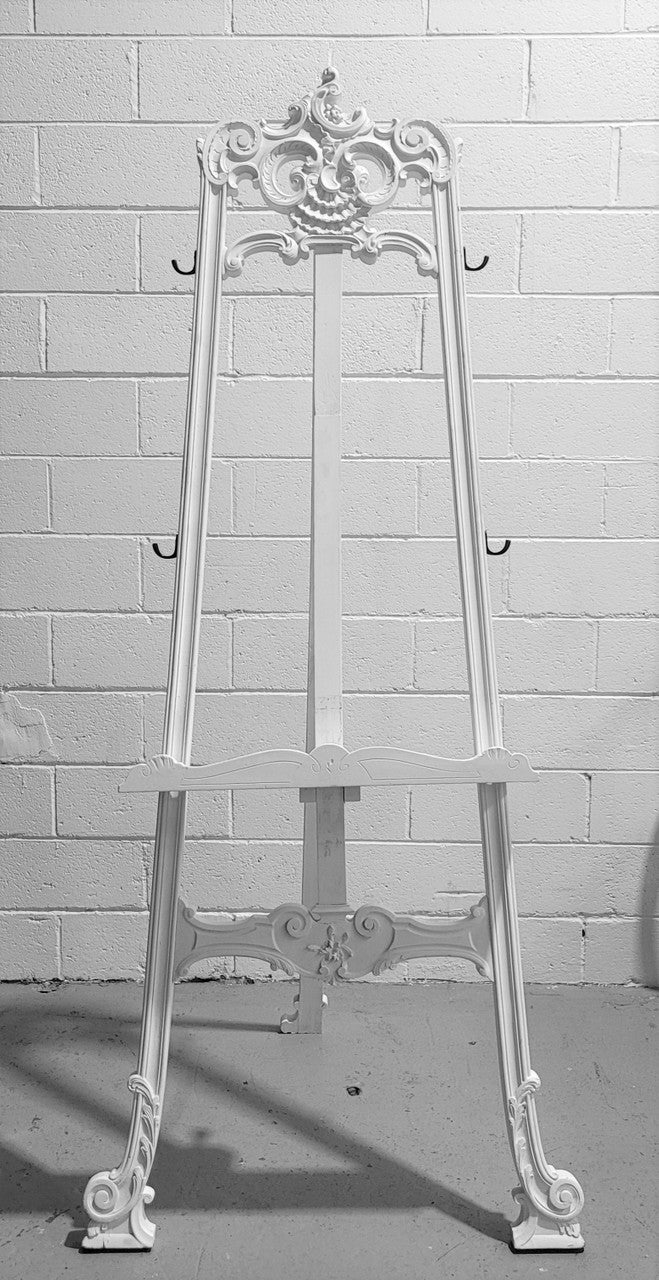 Rococo style white painted French style easel. It can be used as an easel or it has hooks on the sides and could be used to hang other items. In good original condition.