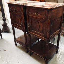 Lovely pair of French Oak Louis XVI style bedside cabinets with inset marble tops a drawer and a cupboard for storage. In good original detailed condition.