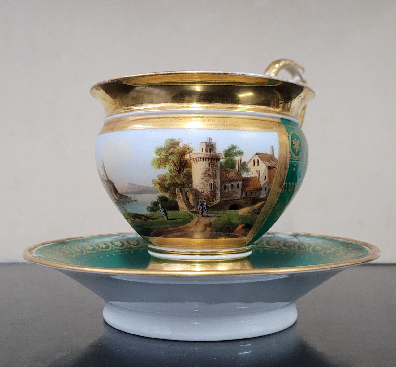 “Old Paris Porcelain” large cup and saucer with hand painted river landscape featuring castles. Gilt and enamel decoration. Circa: early 19th Century. In good original condition please view photos as they help form part of description.