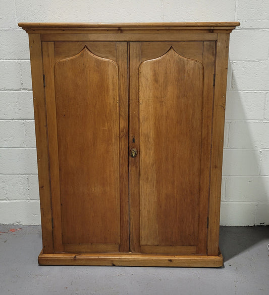 A lovely Victorian Pine shield cupboard with two doors and four shelves in good original detailed condition.