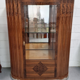 Stunning French Art Deco figured Walnut with Portoro marble top cocktail cabinet. Features chrome trim on base and glass display in door. It is in fully restored condition.
