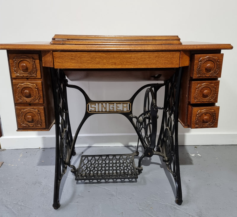 Beautiful Singer sewing machine in an Oak case with six drawers, in mint condition for its age.