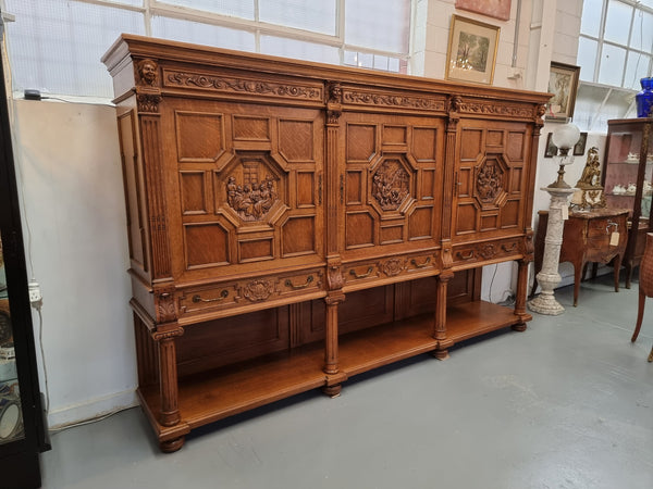 Impressive and grand French Oak Renaissance style sideboard. Beautifully detailed carvings and plenty of storage with three very large cupboards with a total of eight adjustable shelves along with three large drawers. It has been sourced from France and is in very good original detailed condition.