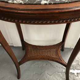 French Fruitwood marble top occasional table. It has two tiers with the bottom being made from cane. In good original condition. Circa 1920's.